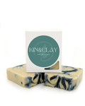 Bar of Kin & Clay Goat's Milk Lavender Soap with lavender-swirl label