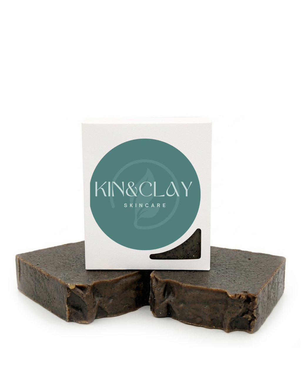 Two bars of Kin & Clay Coffee & Vanilla Bean Body Scrub stacked beside their branded box